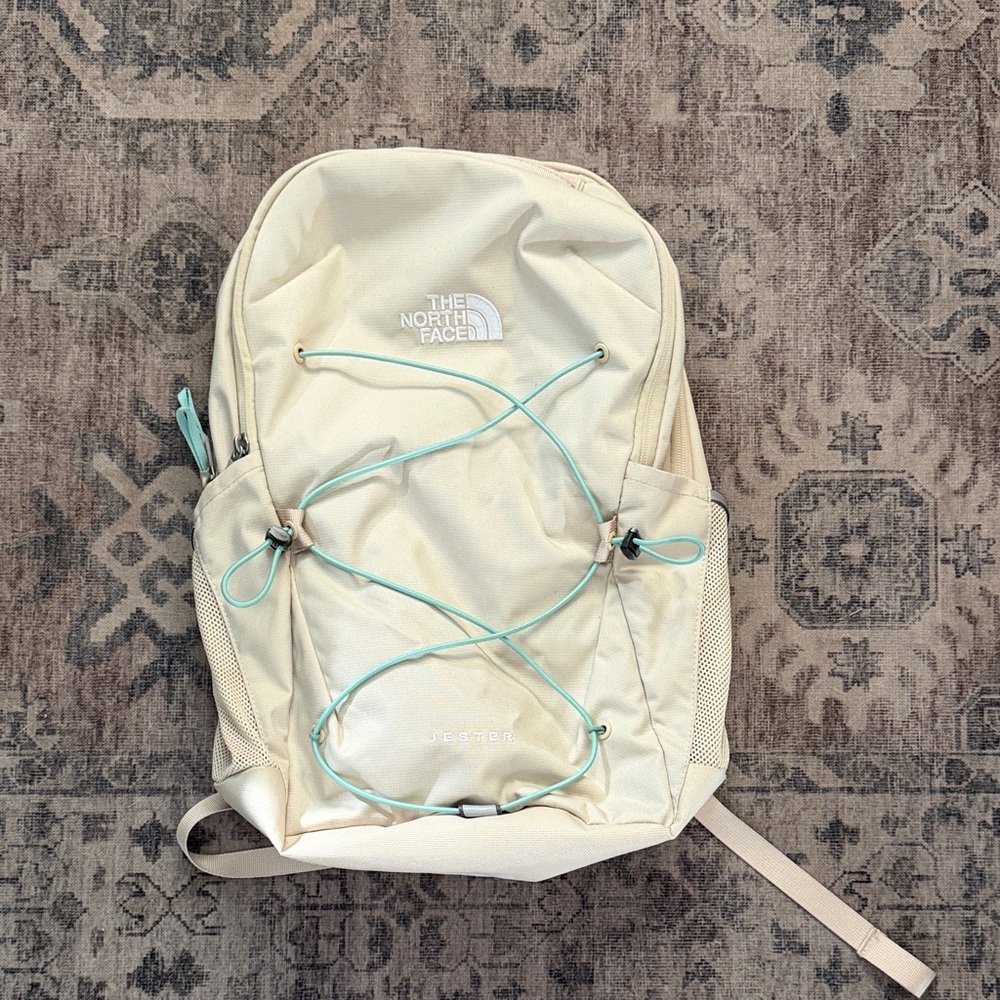 The North Face Off-White Backpack with Light Blue Accents